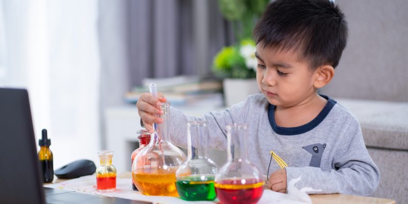 Cute asian primary boy student is talking and enjoy for the online class of science lesson