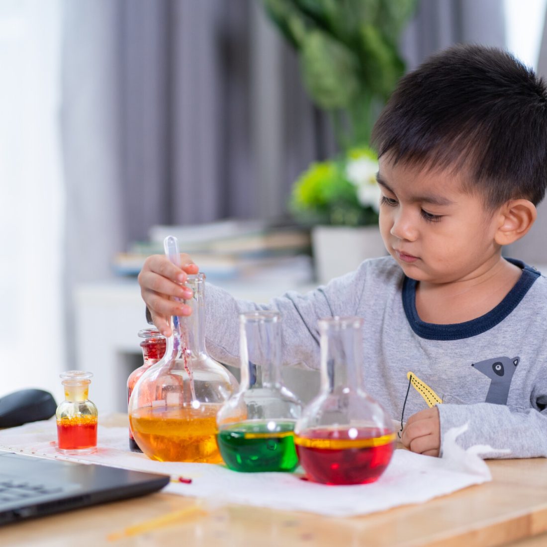 Cute asian primary boy student is talking and enjoy for the online class of science lesson
